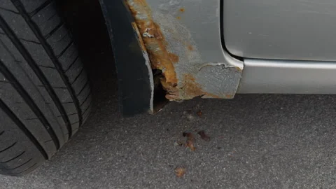A closeup inspection was conducted on the rust damage on the vehicles wheel arch Stock-Footage 307787230