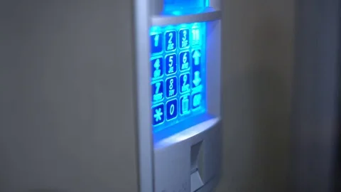 CloseUp to Intercom Entry System while Hand is Entering a Code to Open the Door Vídeo Stock 81560864
