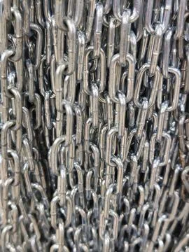 CloseUp of Interlinked Shiny Metal Chain Showing Industrial Strength and Texture Stock Photos