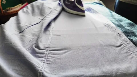 Closeup Of An Iron Using Steam Ironing Clothes And Things Slowmotion Video. Stock Footage 271540401