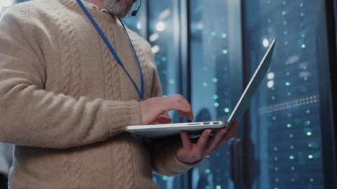 Closeup IT engineer typing on laptop keyboard cloud-based secure data Stock Footage 125404933