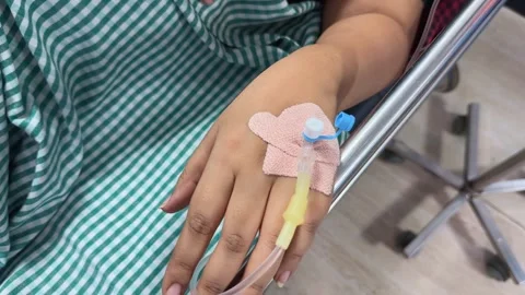 Closeup of iv cannula inserted into a vein 스톡 동영상 313913381
