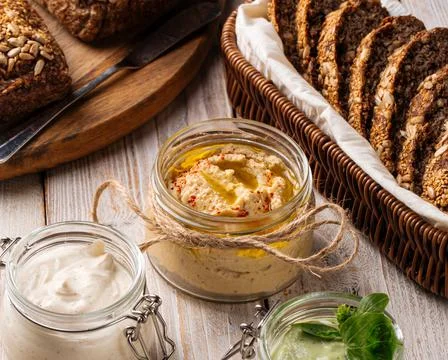 Closeup on a jar of appetizing hummus spread Stock Photos