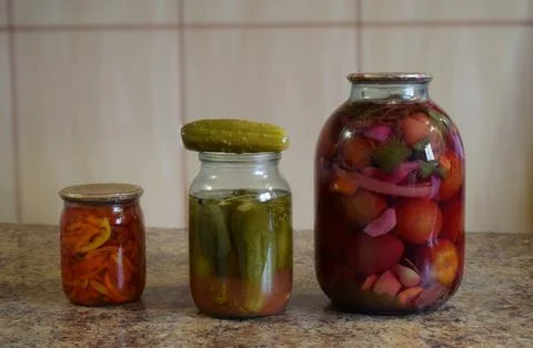 Closeup on jars of pickled vegetables on table Stock Photos