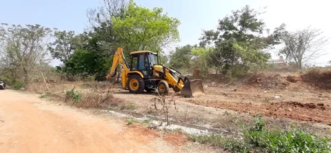 Closeup of JCB cleaning land for construction of building at forest or countr Stock Footage 150863614