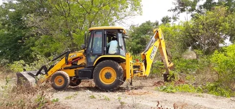 Closeup of JCB cleaning land for construction of building at forest or countr Stock Footage 150863676