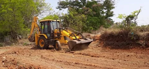 Closeup of JCB cleaning land for construction of building at forest or countr Stock Footage 150863721