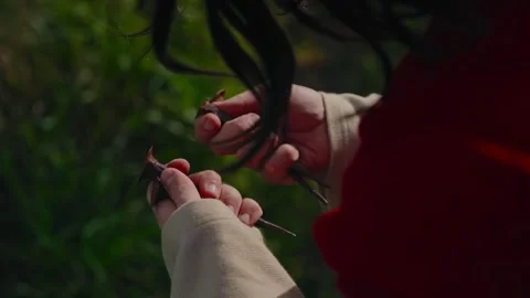 Closeup of Jesus Christ both hands gripping iron crucifixion nails outdoors 库存影片 333096104