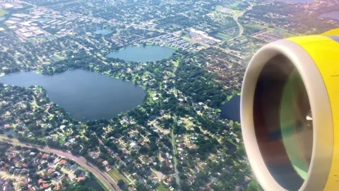 Closeup of a jet engine flying over residential homes Stock Footage 287050514