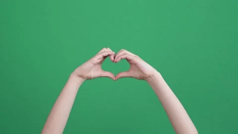 Closeup of kid hands making heart shape gesture on green screen chromakey Stock Footage 151277578