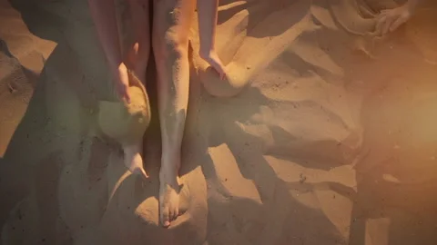 Closeup of kid play or buried legs in sand on beach in summer vacation Stock Footage 145425375