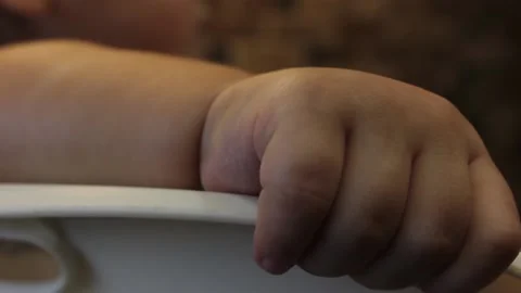Closeup kid's small hand holds the chair Stock Footage 123712190
