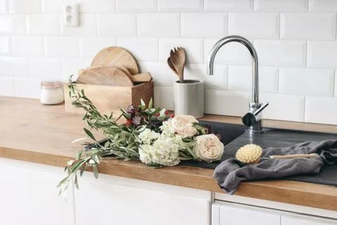 Closeup of kitchen interior. White brick wall, metro tiles, wooden countertops Fotos de archivo