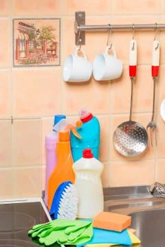 Closeup of kitchen objects - stove, sink and cleaning products Stock Photos