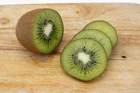 Closeup Kiwi fruit slice on the old wood butcher Stock Photos