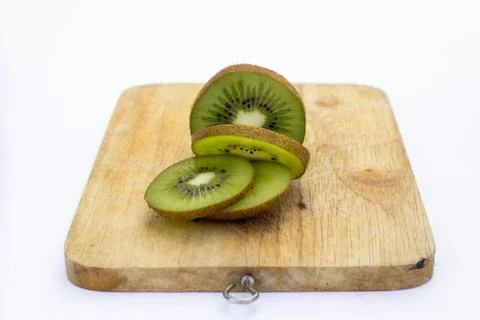 Closeup Kiwi fruit slice on the old wood butcher Stock Photos