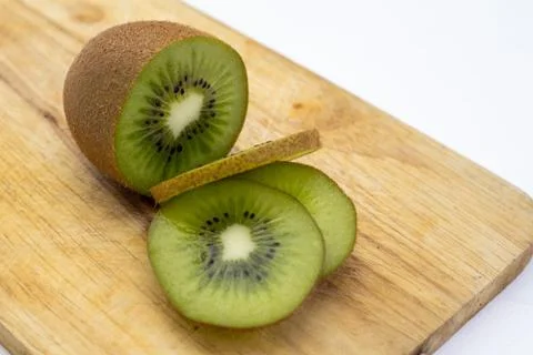 Closeup Kiwi fruit slice on the old wood butcher Stock Photos