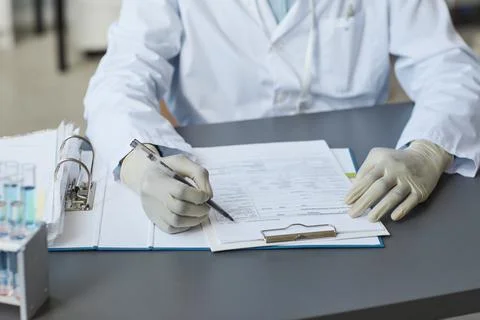 Closeup of Lab Technician Writing in Document Foto stock