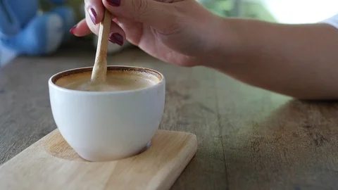 Closeup of lady preparing and eating hot coffee cup Video stock 101007554