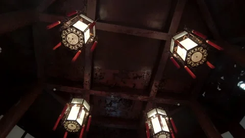 Closeup of lanterns hung on the wood ceiling of Chinese traditional building. Stock Footage 153679305