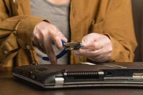Closeup of laptop repair in a computer workshop. Concept of replacing faulty  Stock Photos