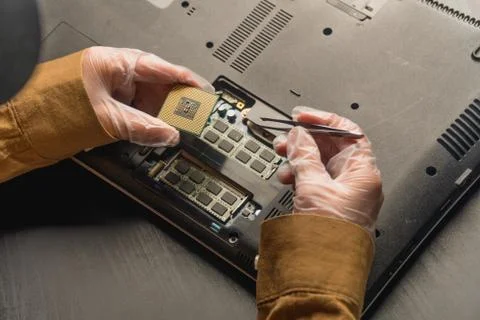 Closeup of laptop repair in a computer workshop. Concept of replacing faulty  Stock Photos