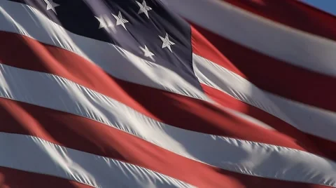 Closeup of a large American flag waving in the wind Stock Footage 56334209