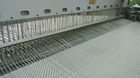 Closeup large loom weaves white synthetic fiber Stock Footage