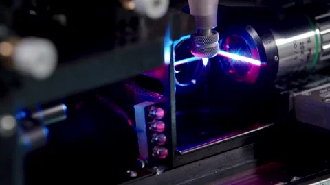 Closeup of a laser cutting Quantum engineering machine with purple light Stock Footage 245839477