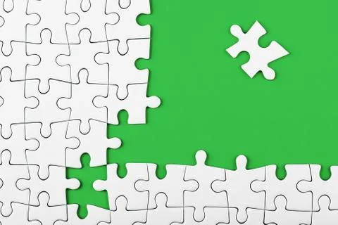 Closeup of the last piece of puzzle missing on green background Stock Photos