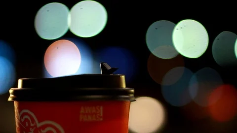 Closeup of latte coffee paper cup with bokeh of light in the background. Stock Footage 106282178