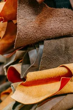 Closeup of layered leather sheets with rough textures and contrasting red brown Stock-Fotos
