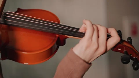Closeup left hand on violin showing fingertip placement and precise finger Stock Footage 346555771
