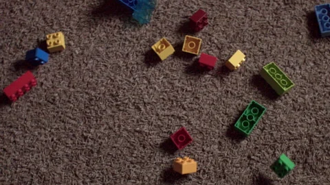 Closeup of legos dropping on floor Video stock 245402498