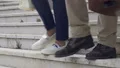 Closeup of legs walking down stairs, colleagues leaving office after workday HD Footage