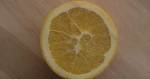 Closeup of a lemon wedge on wood table Stock Footage 146397477