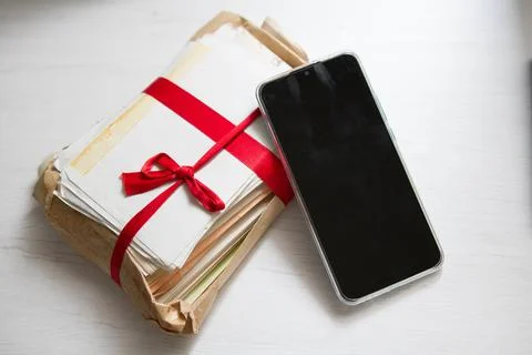 Closeup of the letters with a phone. Difference between traditional letters and Stock Photos