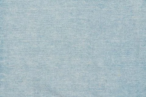 Closeup of light blue denim texture. Faded jeans fabric background with class Stock Photos