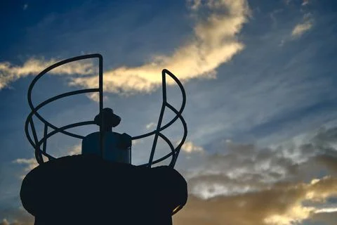 Closeup of lighthouse and clouds at sunset in a coastal area. Stock Photos