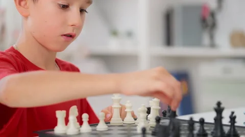 Closeup of little boy improving critical thinking while playing chess at home Stock Footage 230922083