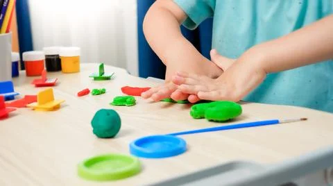 Closeup of little boy using plastic forms for shaping and sculpting toy Foto stock