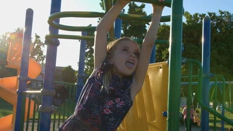 Young Girl Playing On Slide In Playground Stock Photo by ©monkeybusiness  102795610