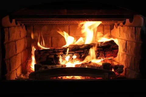 Closeup of a log burning in a fireplace Stock Photos