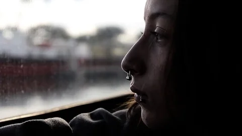 Closeup of lonely person looking out of moving boat Stock Footage 83035575