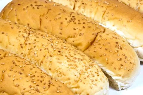 Closeup of long white breadrolls sprinkled with sesame seeds Stock Photos
