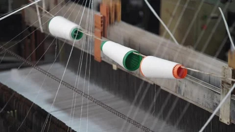 Closeup of a loom and thread spools used in textile production Stock Footage 299776780