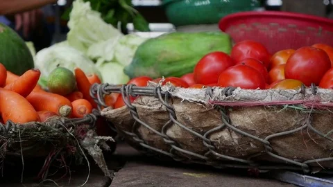 Closeup of a lot of vegetables in wicker baskets on the local market Stock Footage 81168380