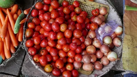 Closeup of a lot of vegetables in wicker baskets on the local market Stock Footage 81168682