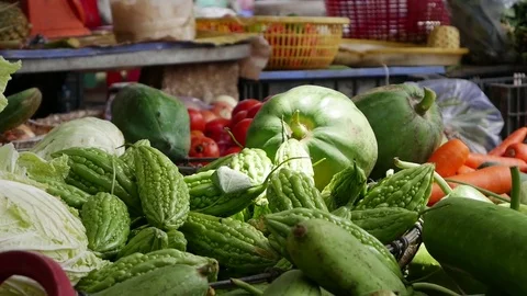 Closeup of a lot of vegetables in wicker baskets on the local market Stock Footage 81169032