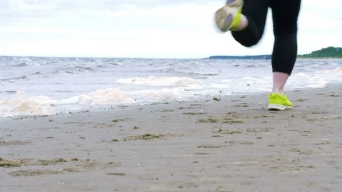 Closeup low angle shot of running woman legs cross the frame Stock Footage 82410763